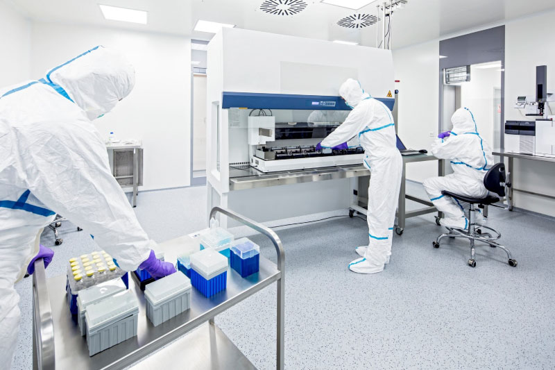 Scientists wearing full protective gear in a laboratory.