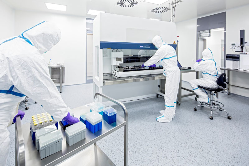 A group of scientists wearing protective gear inside the lab.